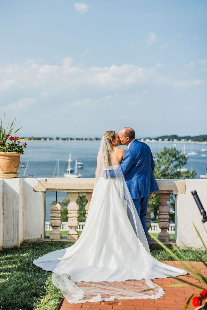 Bride and groom kiss at Vanderbilt Museum